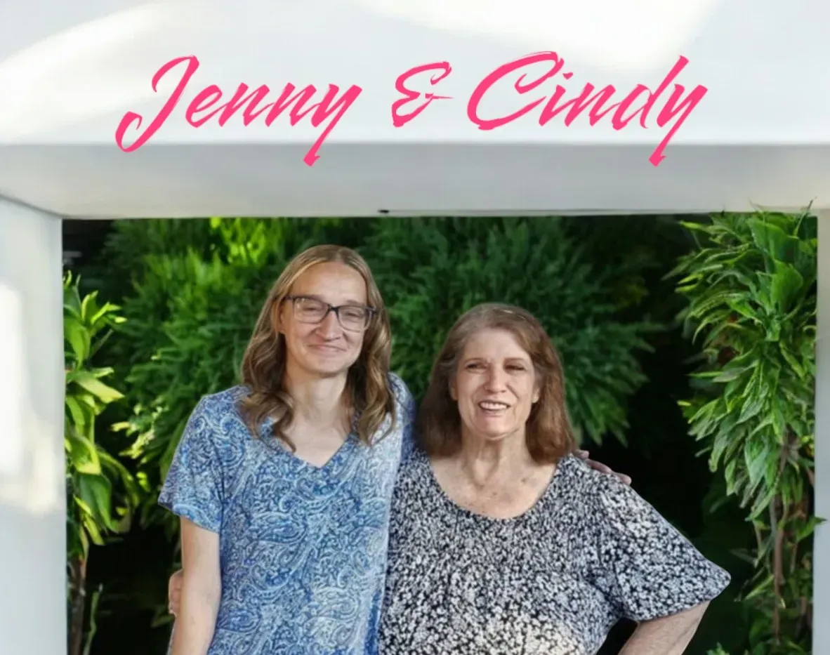 Two women standing under a sign that says jenny and cindy