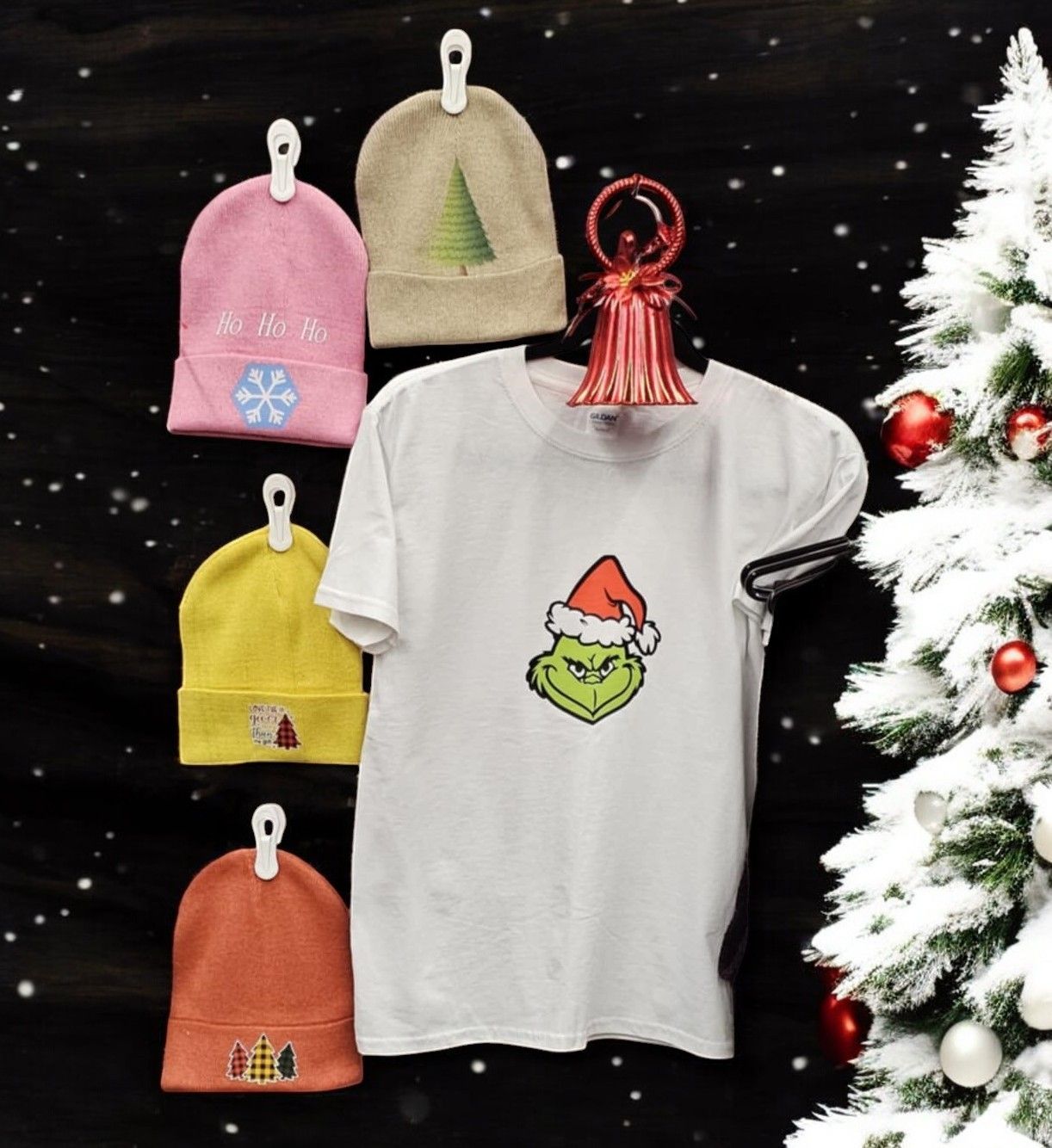 A grinch t-shirt is hanging next to a christmas tree