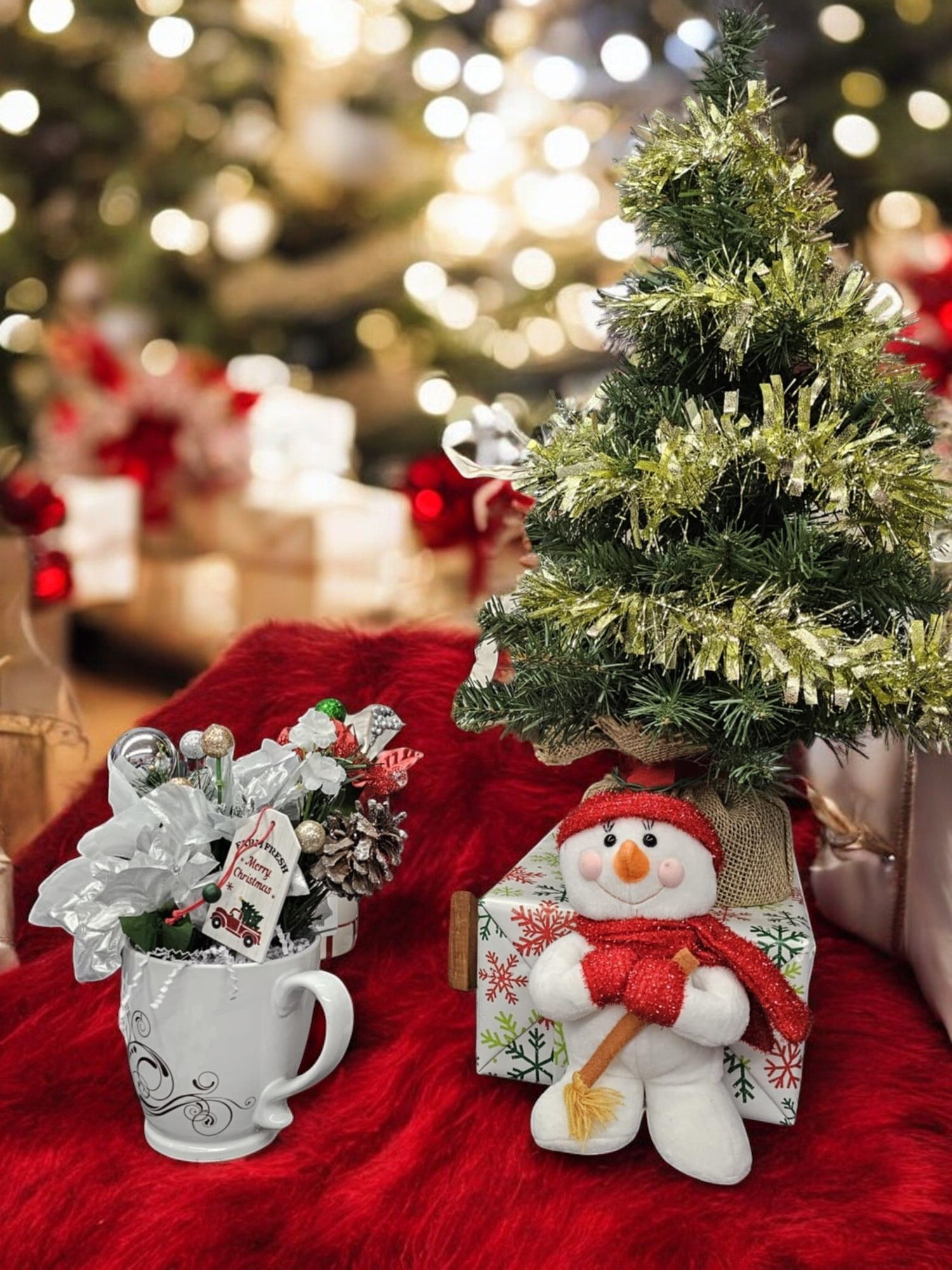 There is a christmas tree and a snowman on the table.