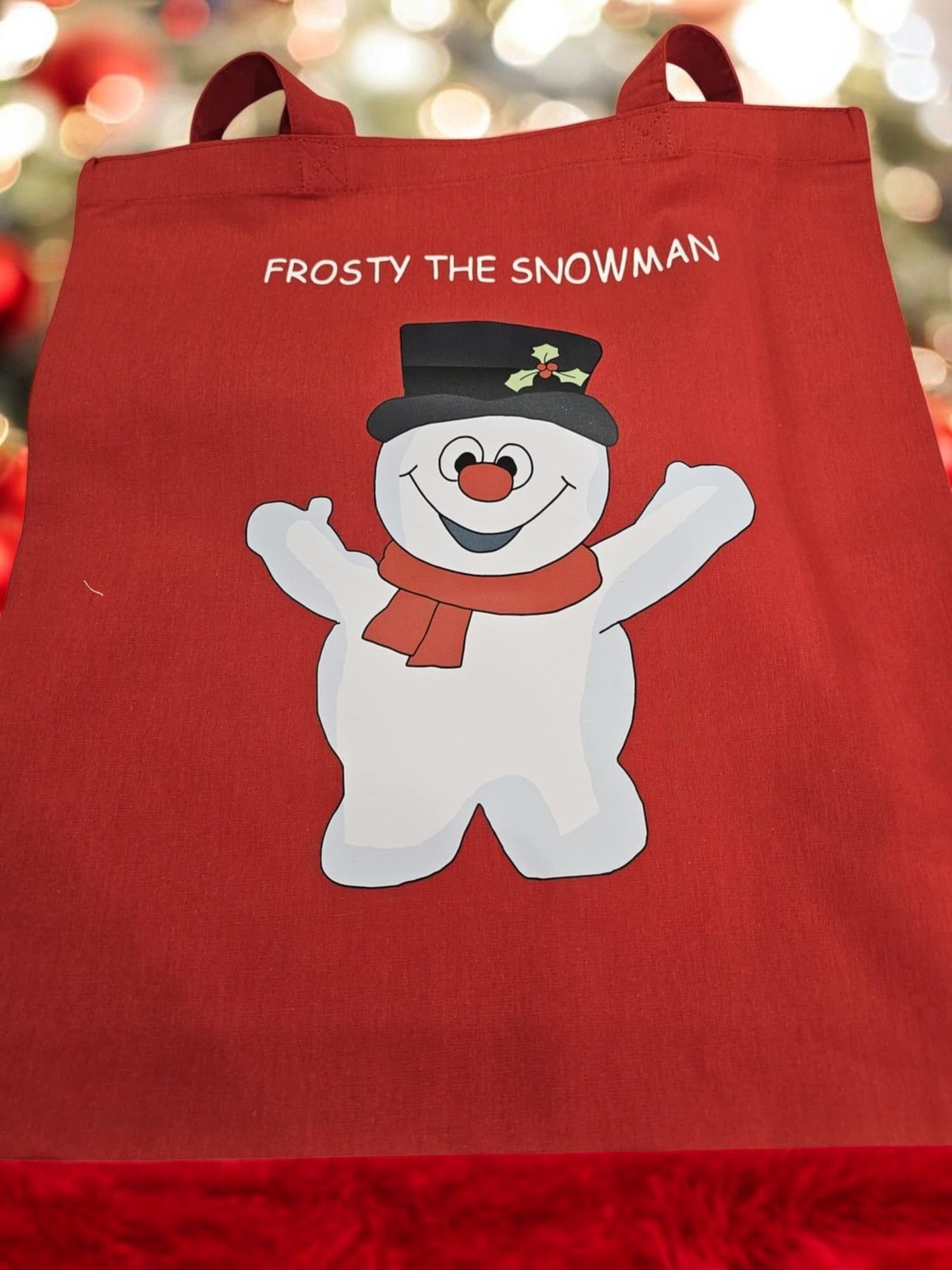 A red bag with a snowman on it that says frosty the snowman