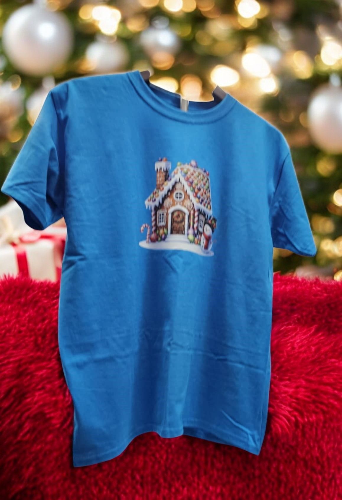 A blue t-shirt with a gingerbread house on it