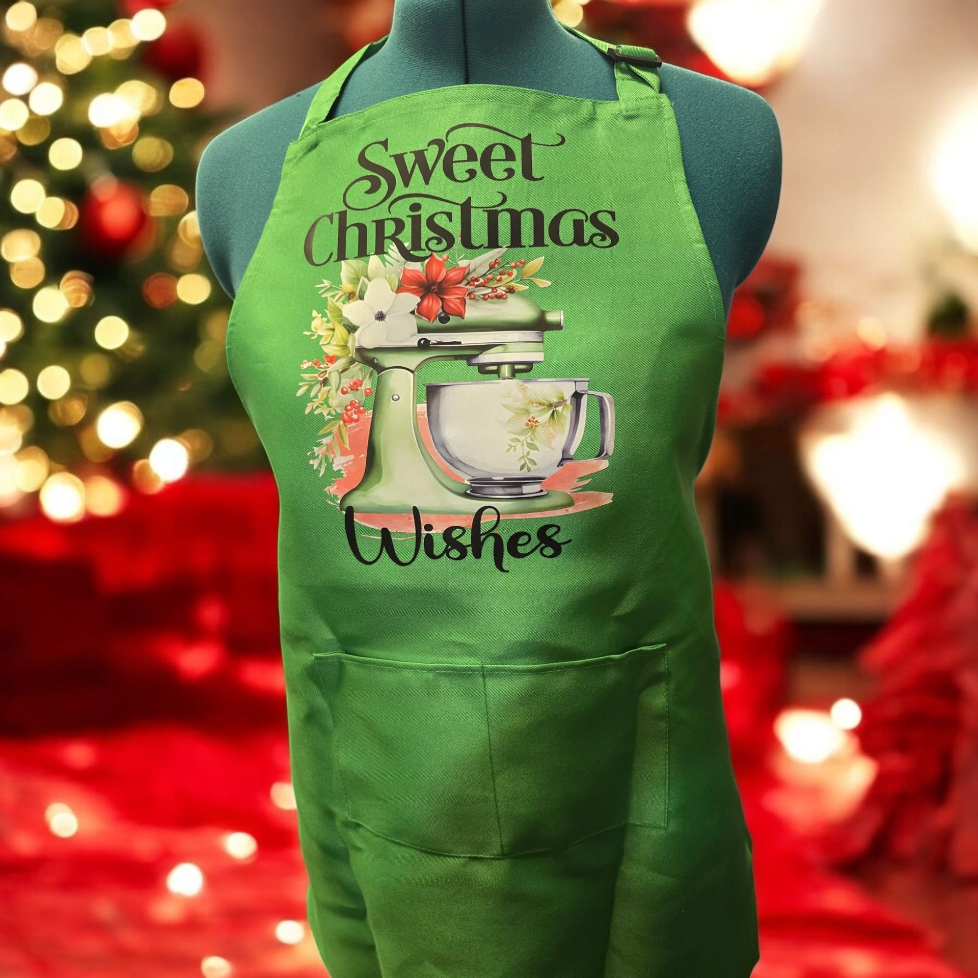 A green apron that says sweet christmas wishes on it
