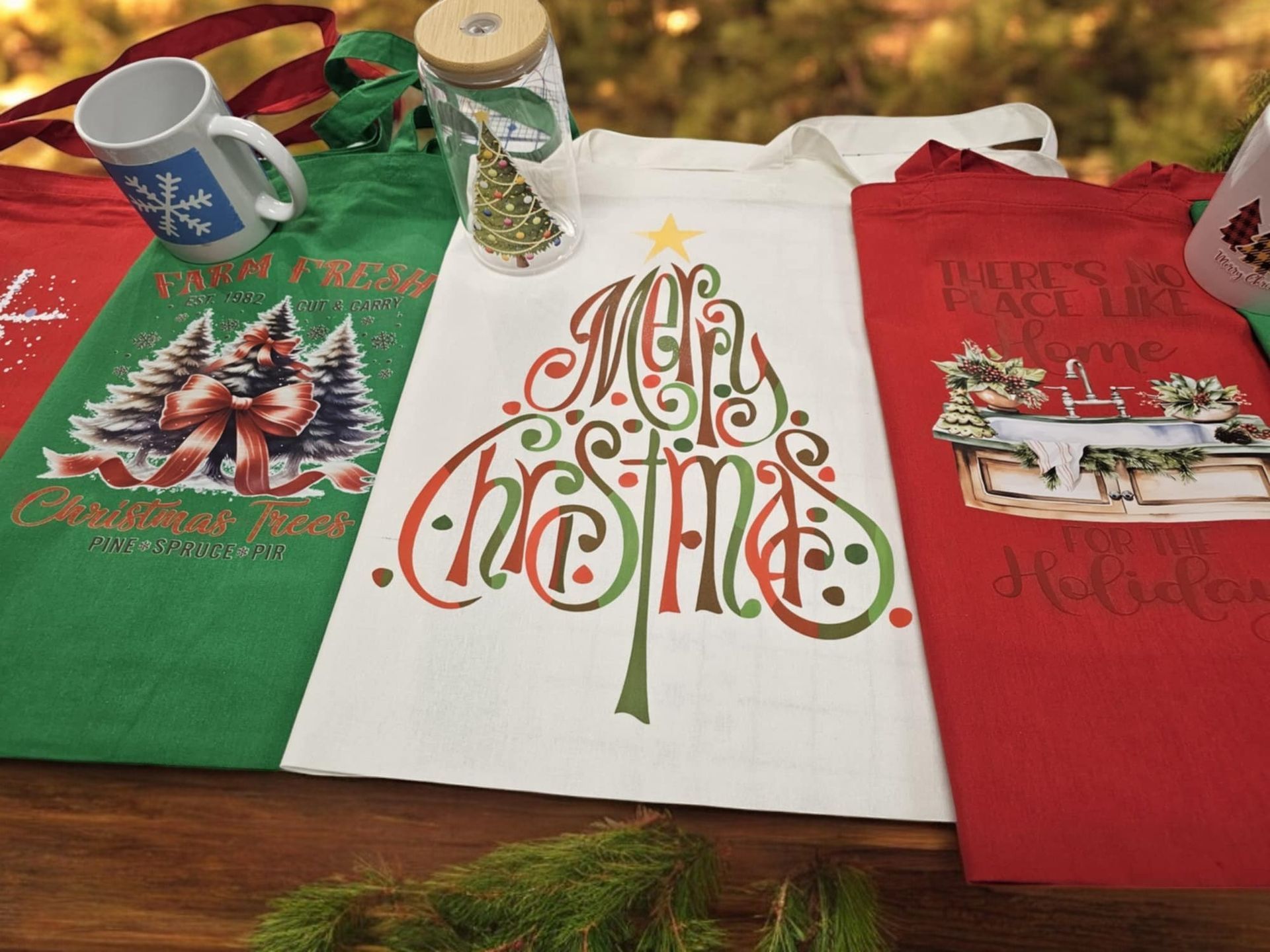 A group of christmas towels are sitting on a wooden table.