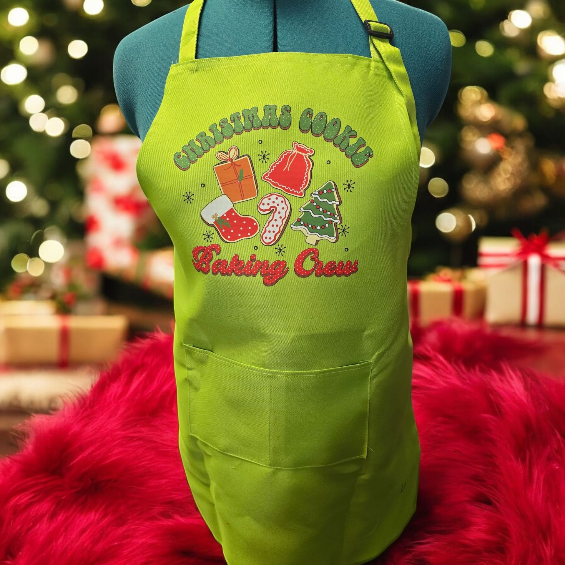A green apron that says christmas cookies on it