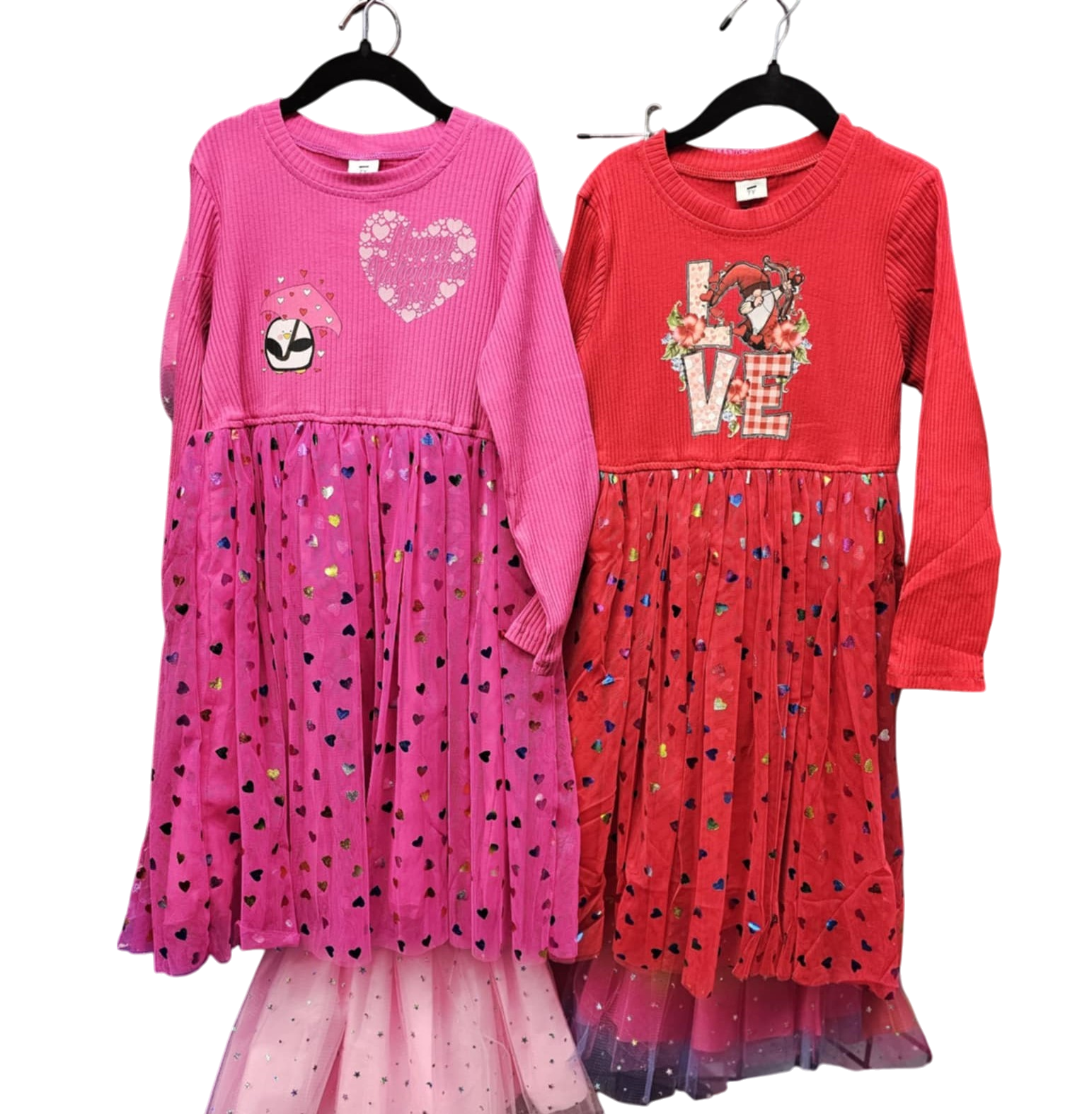 A pink and a red dress are hanging on a hanger