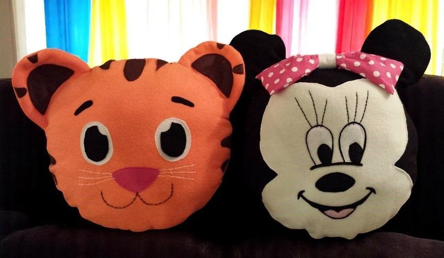 A tiger and a minnie mouse pillow on a couch
