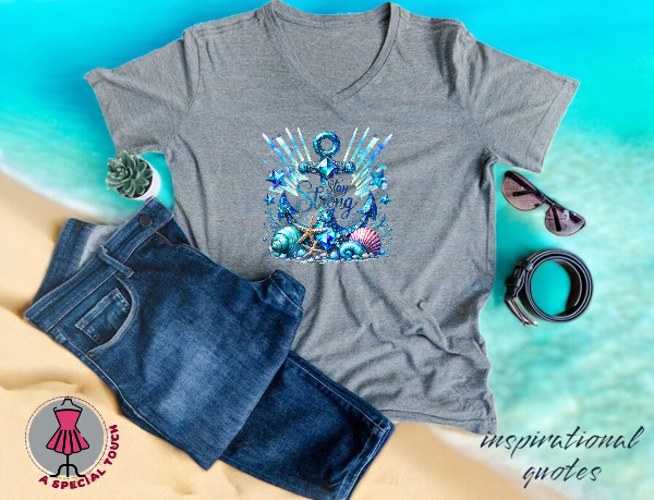 A t-shirt with an anchor on it is on a beach