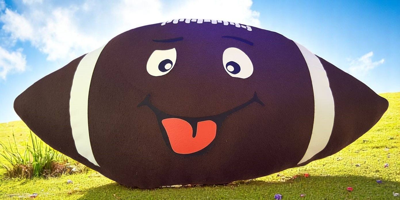 A stuffed football with a face and tongue sticking out
