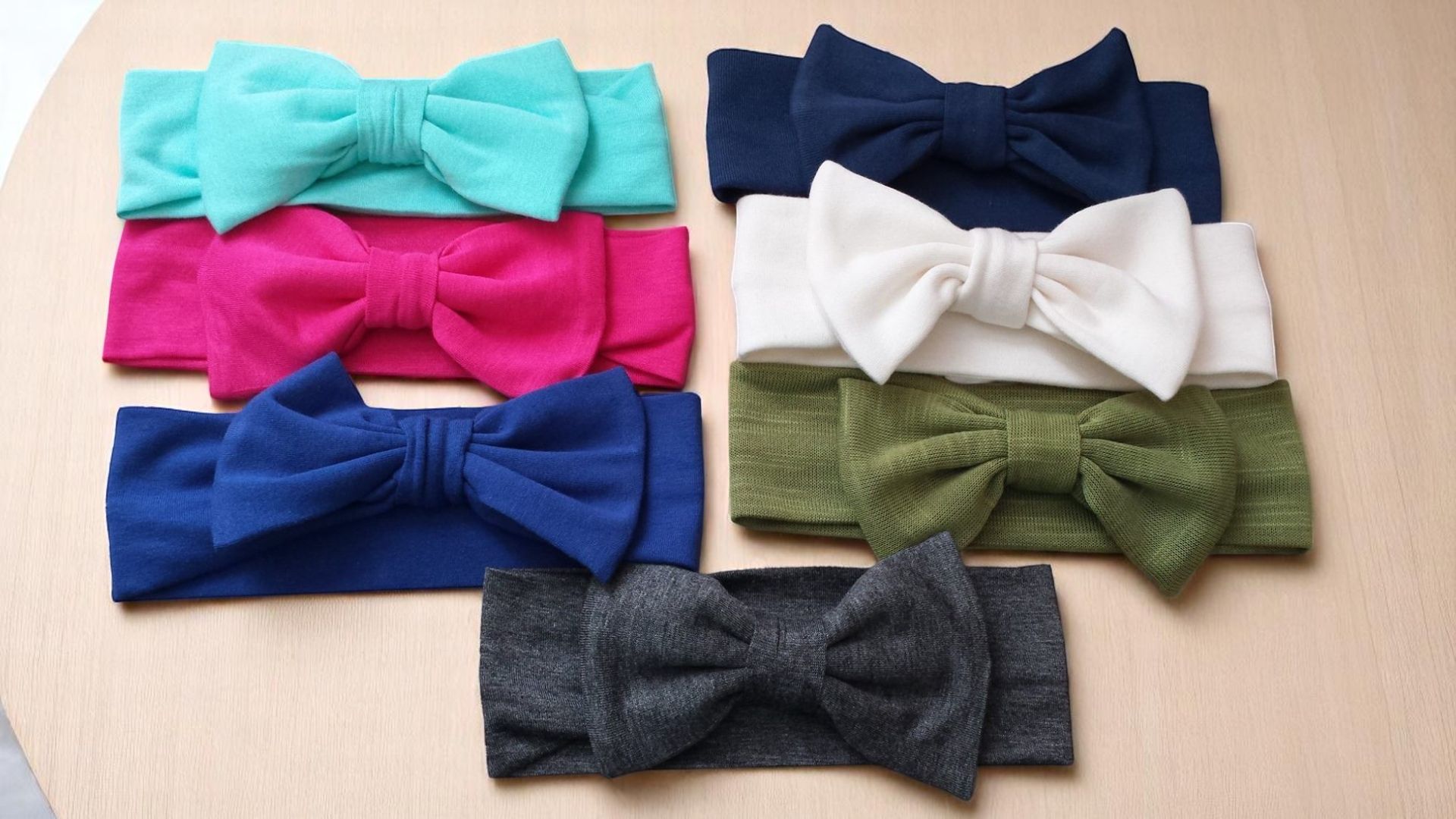 A bunch of headbands with bows on them on a table