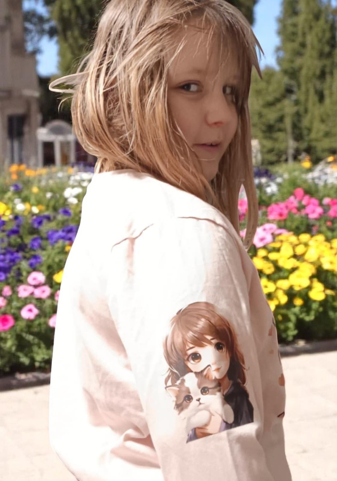 A young girl with a picture of a doll on her sleeve