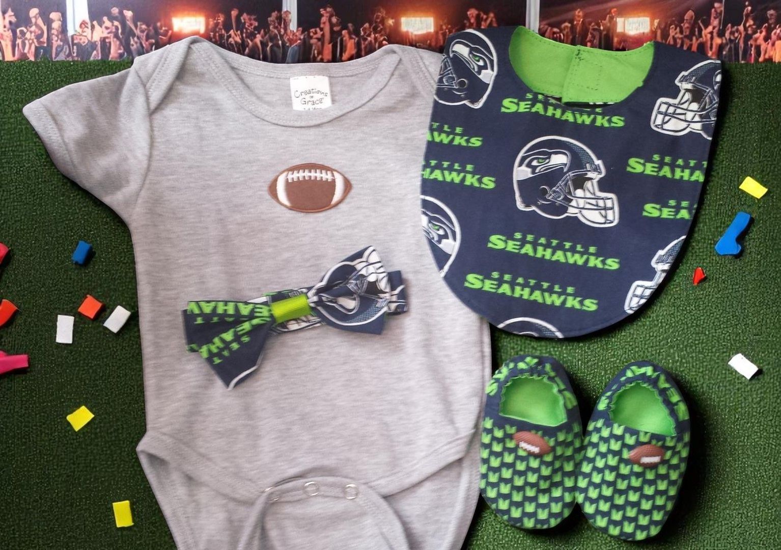 A baby wearing a seahawks shirt bib and shoes