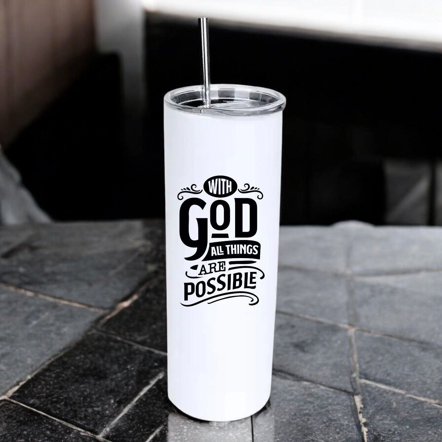 A stainless steel tumbler with a straw and the words `` with god all things are possible ''.