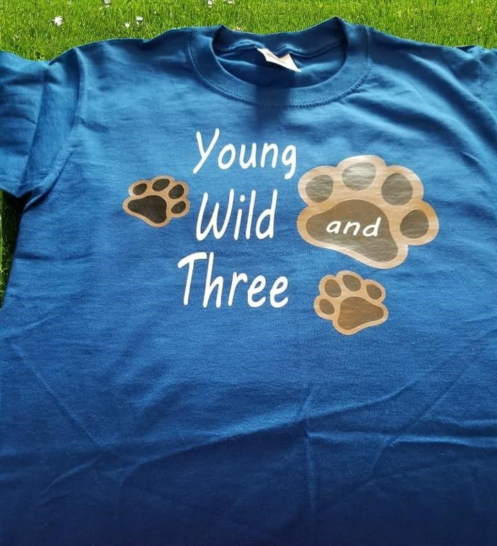 A blue shirt that says young wild and three