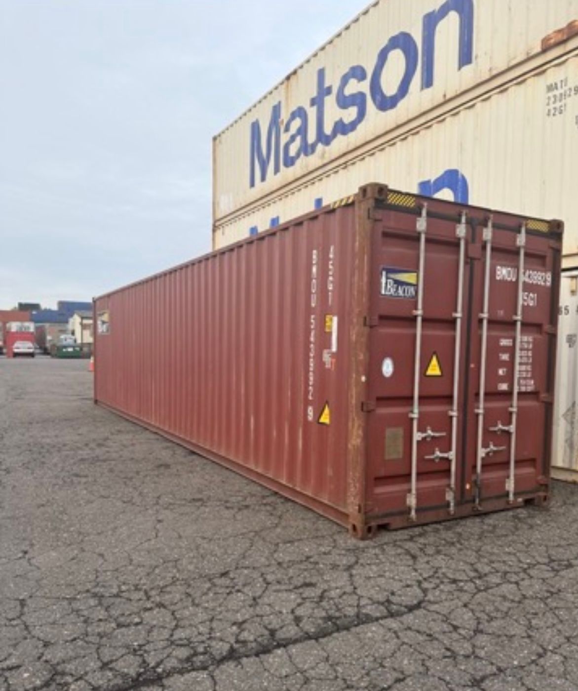 A blue, corrugated steel shipping container isolated on a white background.