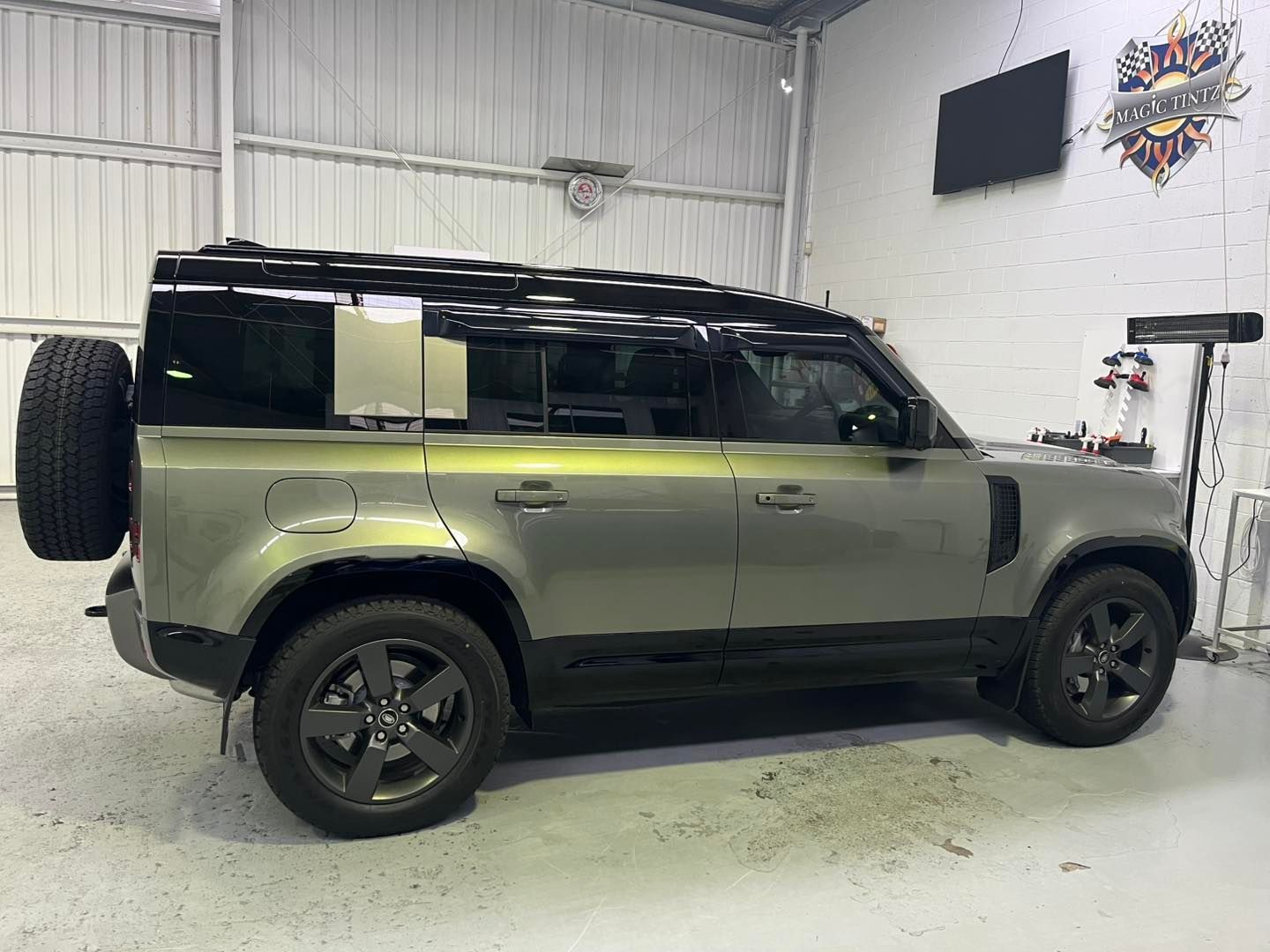 A Profile View of a Light Green Land Rover Defender — Magic Tintz in Moonah, TAS