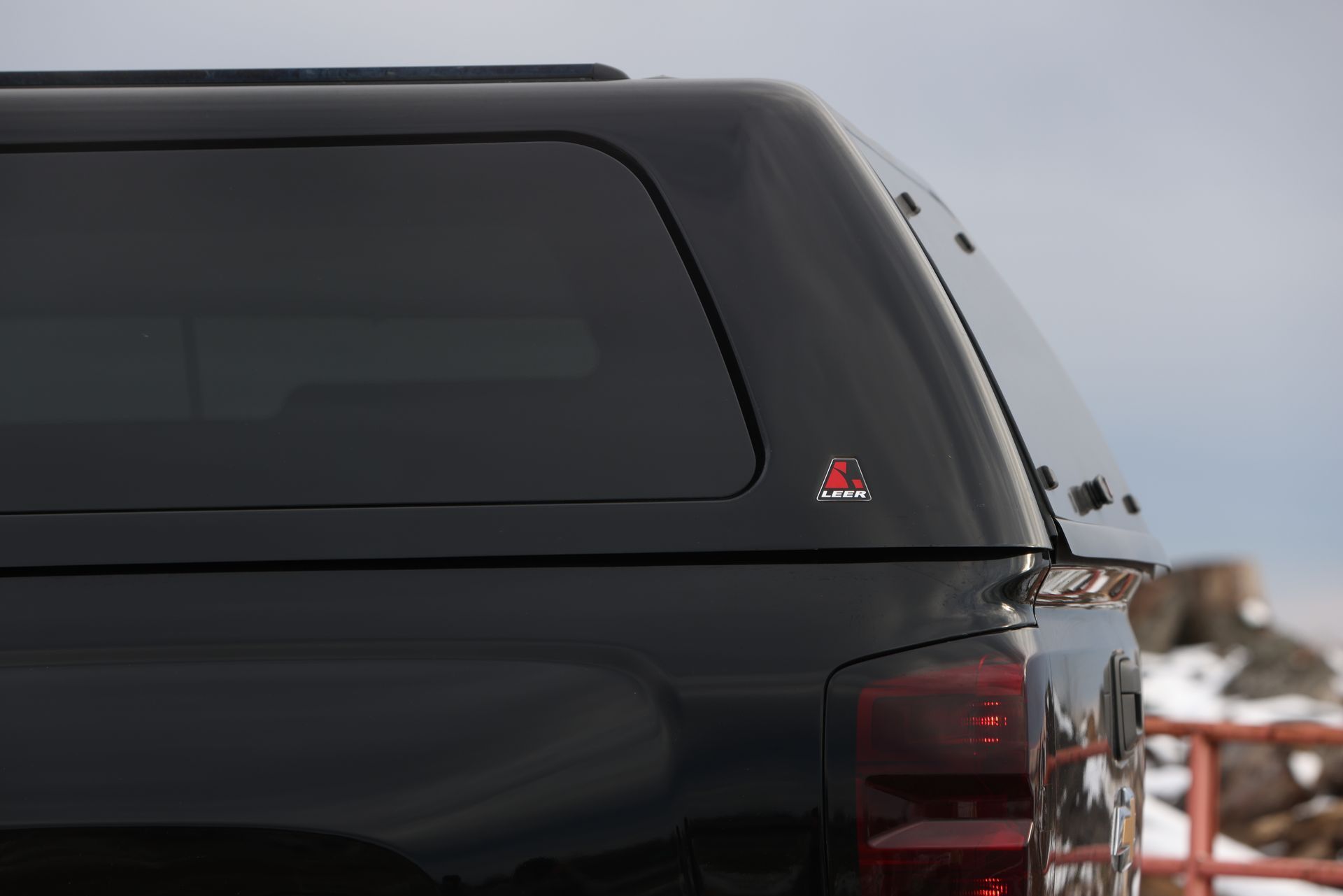 A black truck with a canopy on top of it.