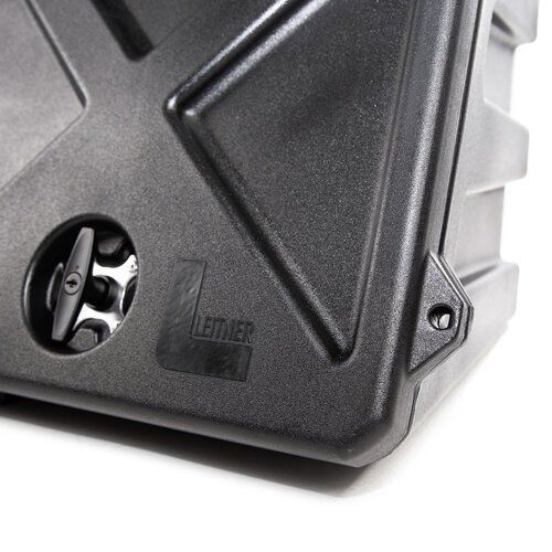 A close up of a black plastic container with the letter l on it