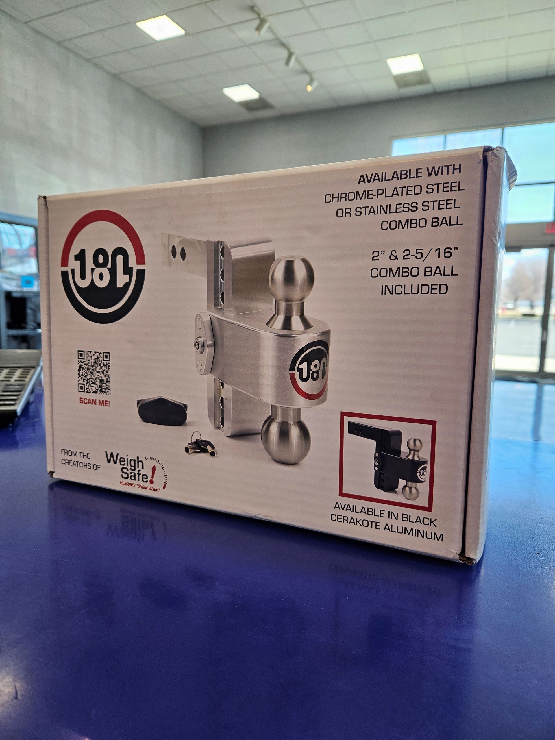 A box of a door lock is sitting on a blue table.