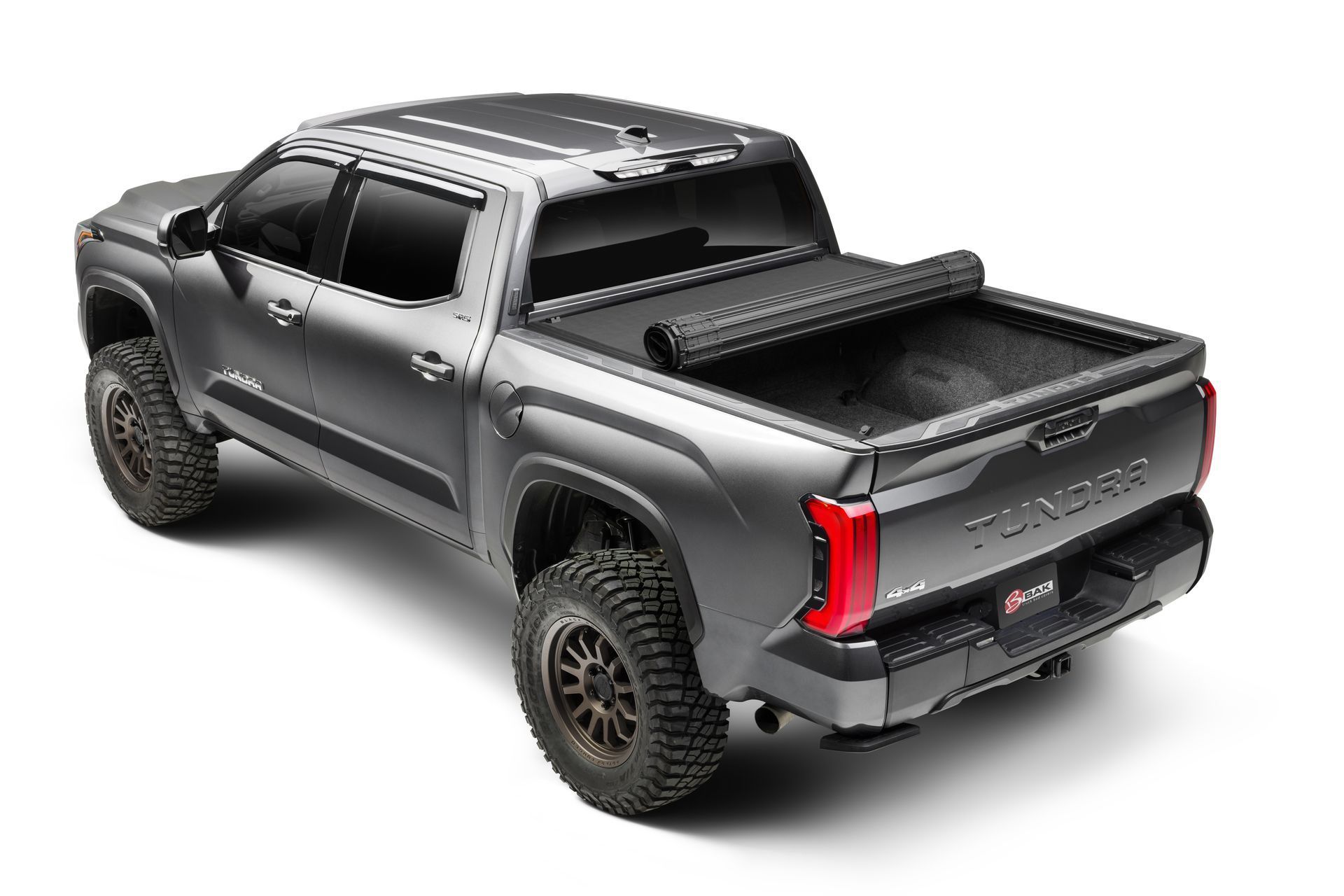 The back of a toyota tacoma truck with a bed cover on it.