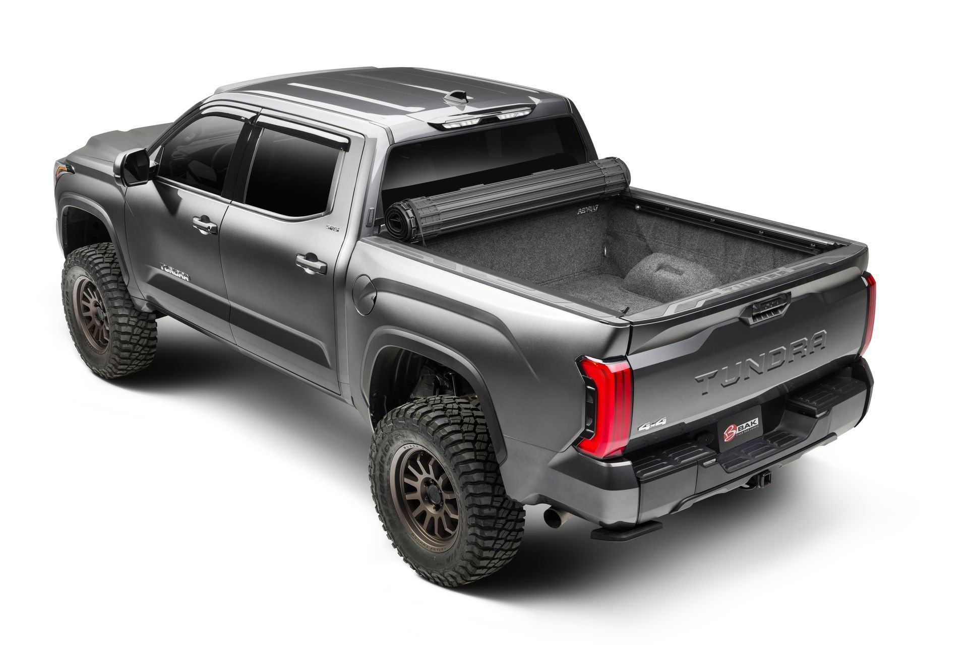 The back of a toyota tacoma truck with a roll up bed cover.