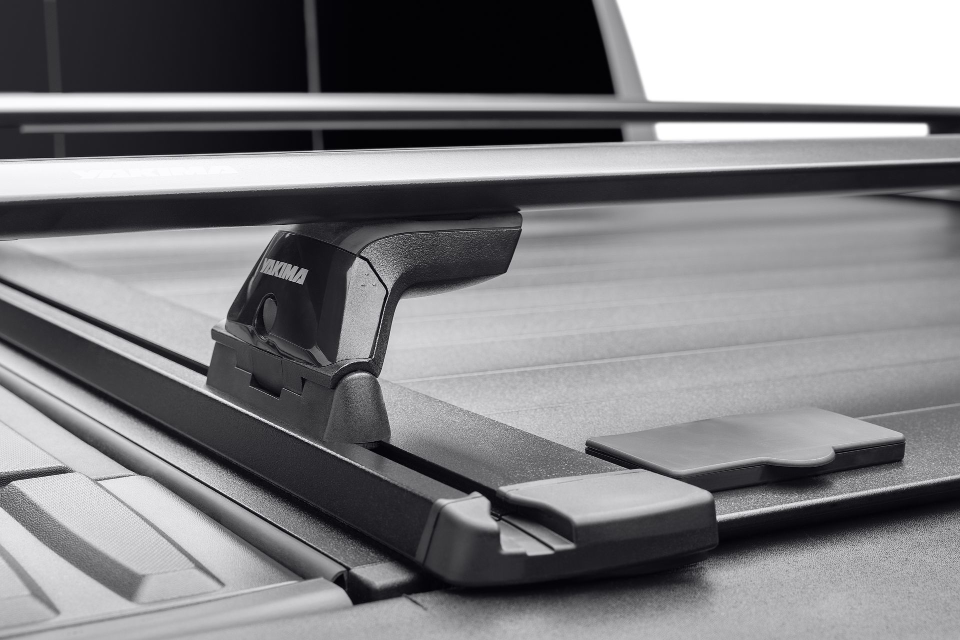 A black and white photo of a roof rack on a truck bed.