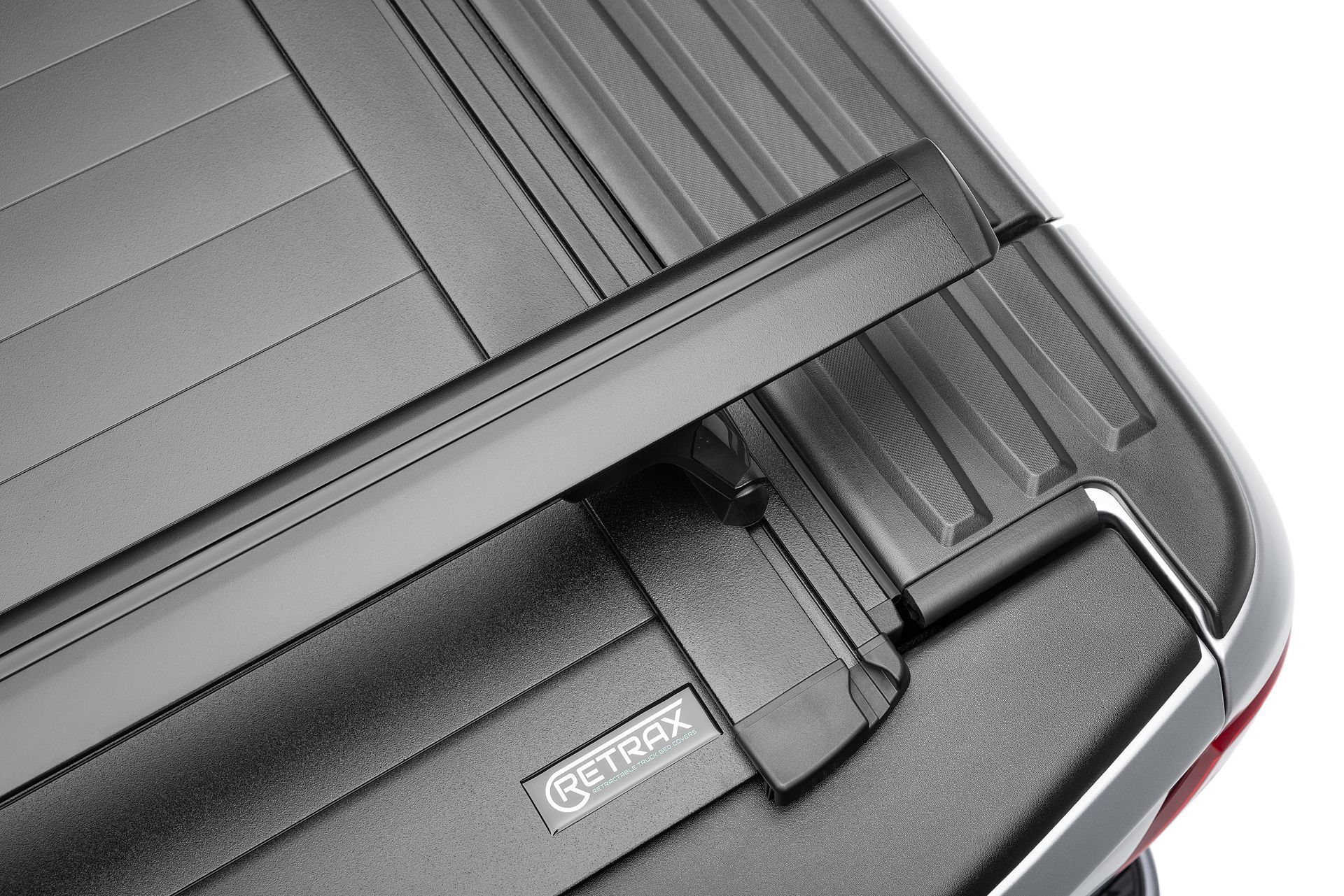 A close up of a black tonneau cover on a truck.