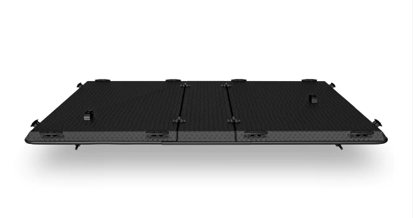 A black item is sitting on a white surface.
