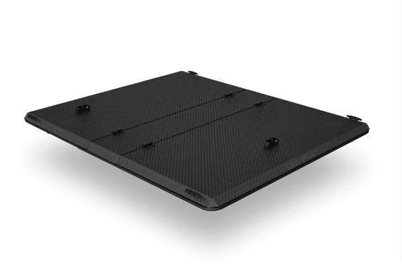 A black box is sitting on a white surface.