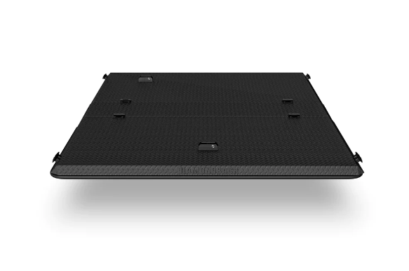A black laptop is sitting on a white surface.
