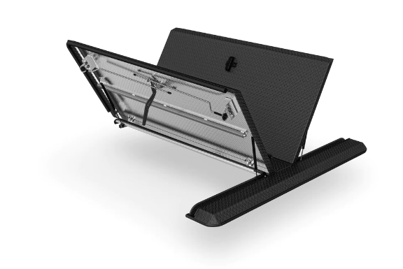 A laptop is sitting on a stand with the lid open.