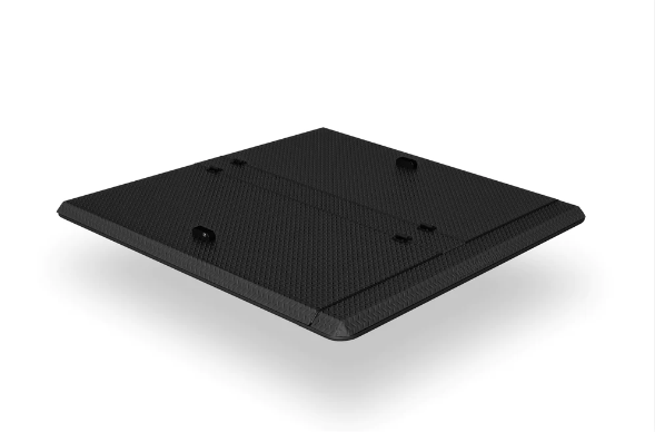 A black square object is sitting on a white surface.