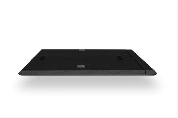 A black tablet is sitting on a white surface.