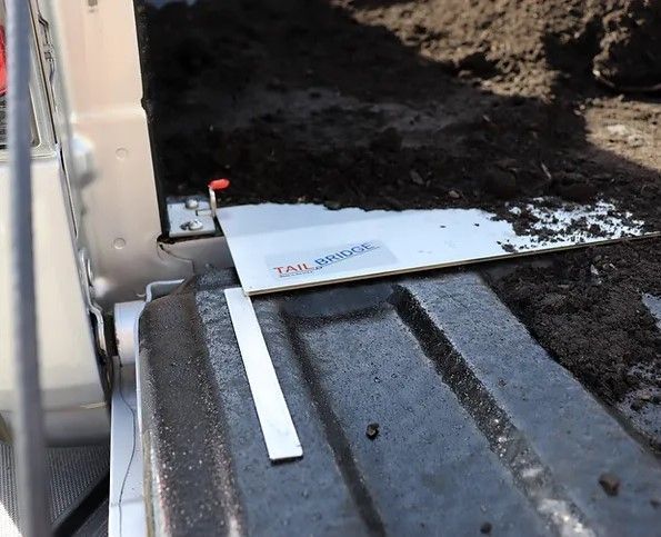 A piece of metal is sitting on top of a truck bed.