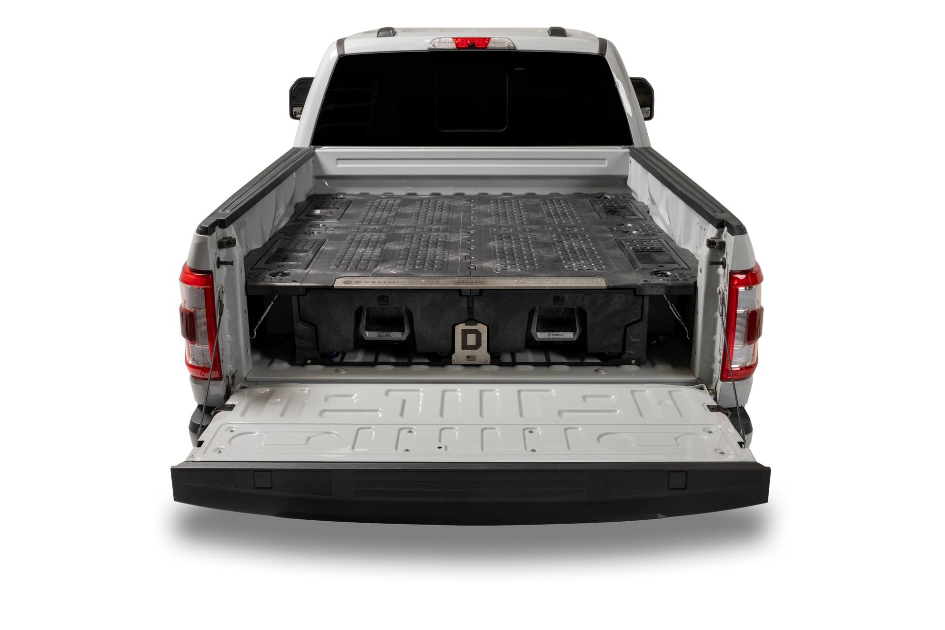 The back of a white truck with the bed open.