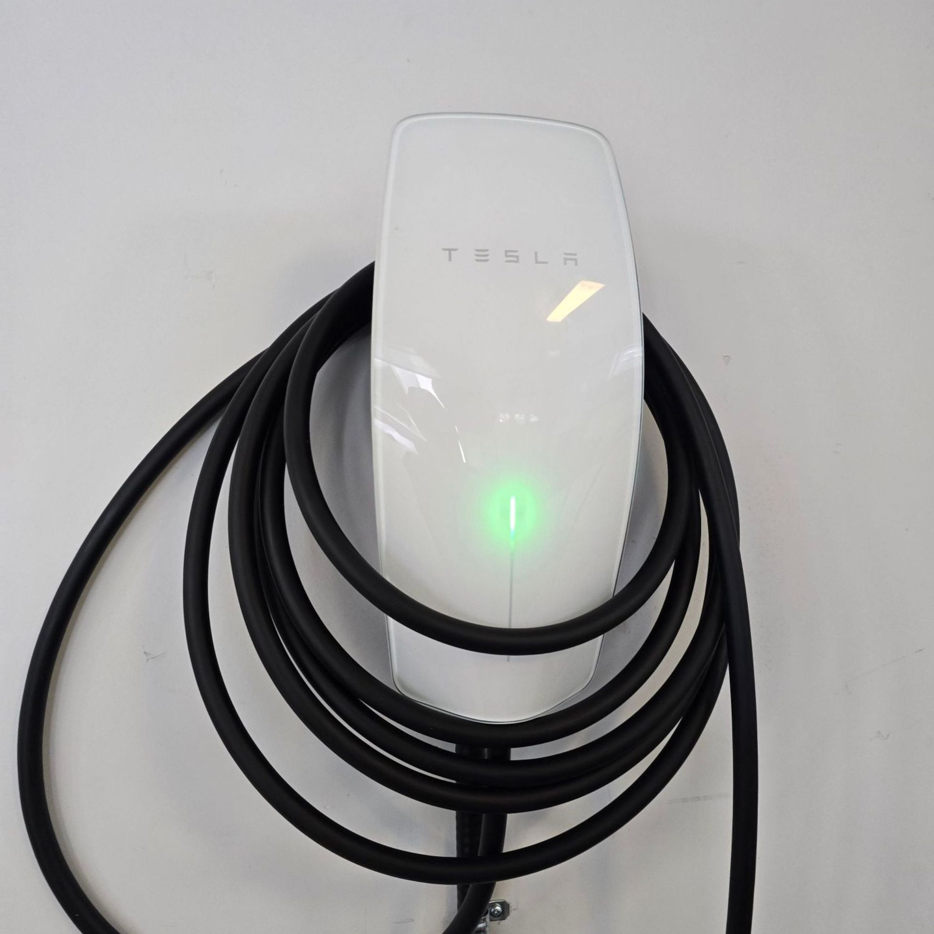 MJS Electrical Services - Empty garage interior with EV chargers, solar panels on roof.