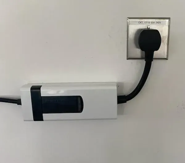 A plug is plugged into a wall outlet.