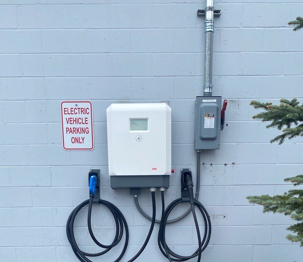 An electric vehicle charging station on the side of a building