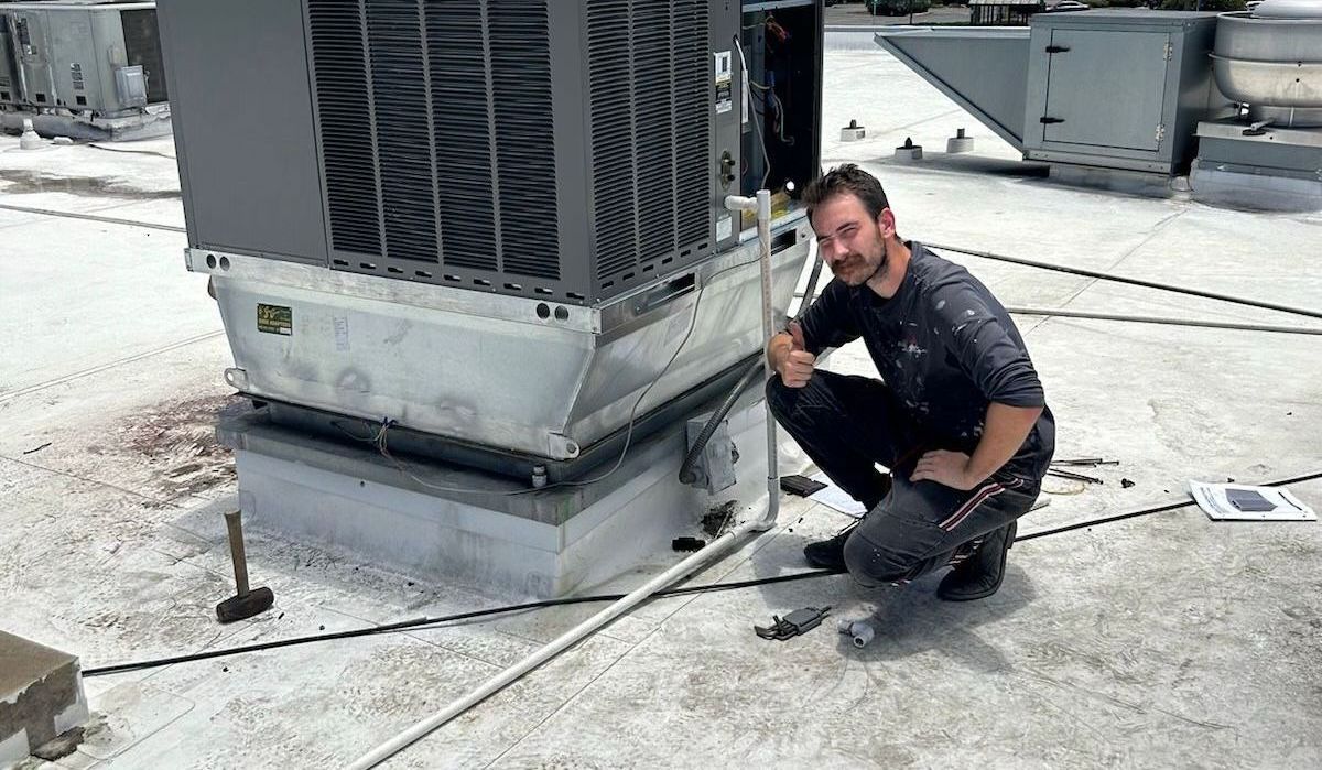 An HVAC contractor checking an HVAC unit in Holiday, FL
