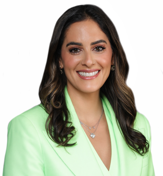 Woman in black scrubs, smiling with arms crossed.