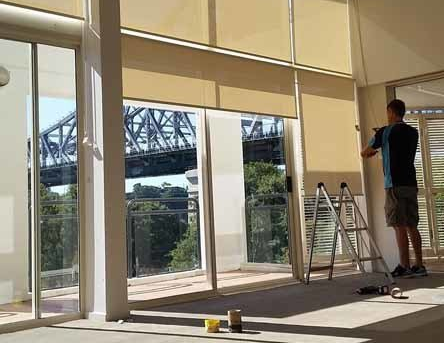 Blinds Being Installed In Home — Brisbane, QLD — Sun Stop Blinds