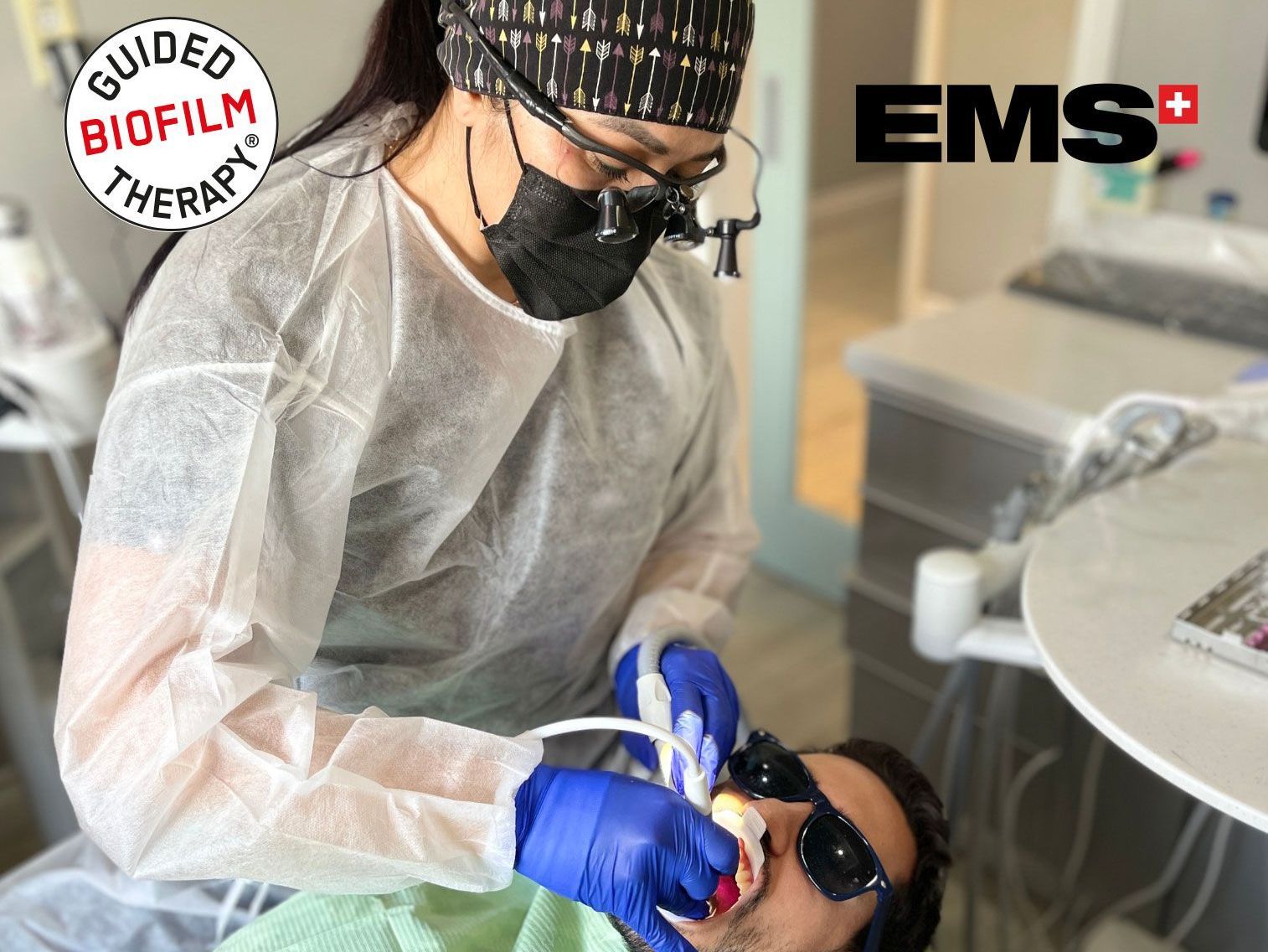 A dentist is examining a patient's teeth in a dental office