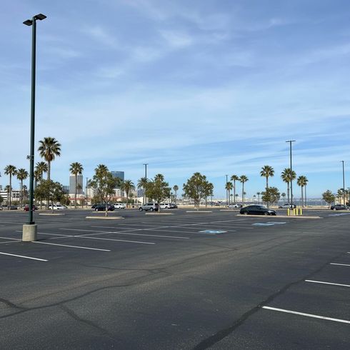 Professional parking lot striping at a gas station with clear yellow lines and numbered spaces