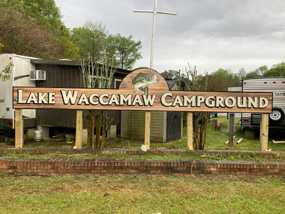 A large wooden sign for lake waccamaw campground
