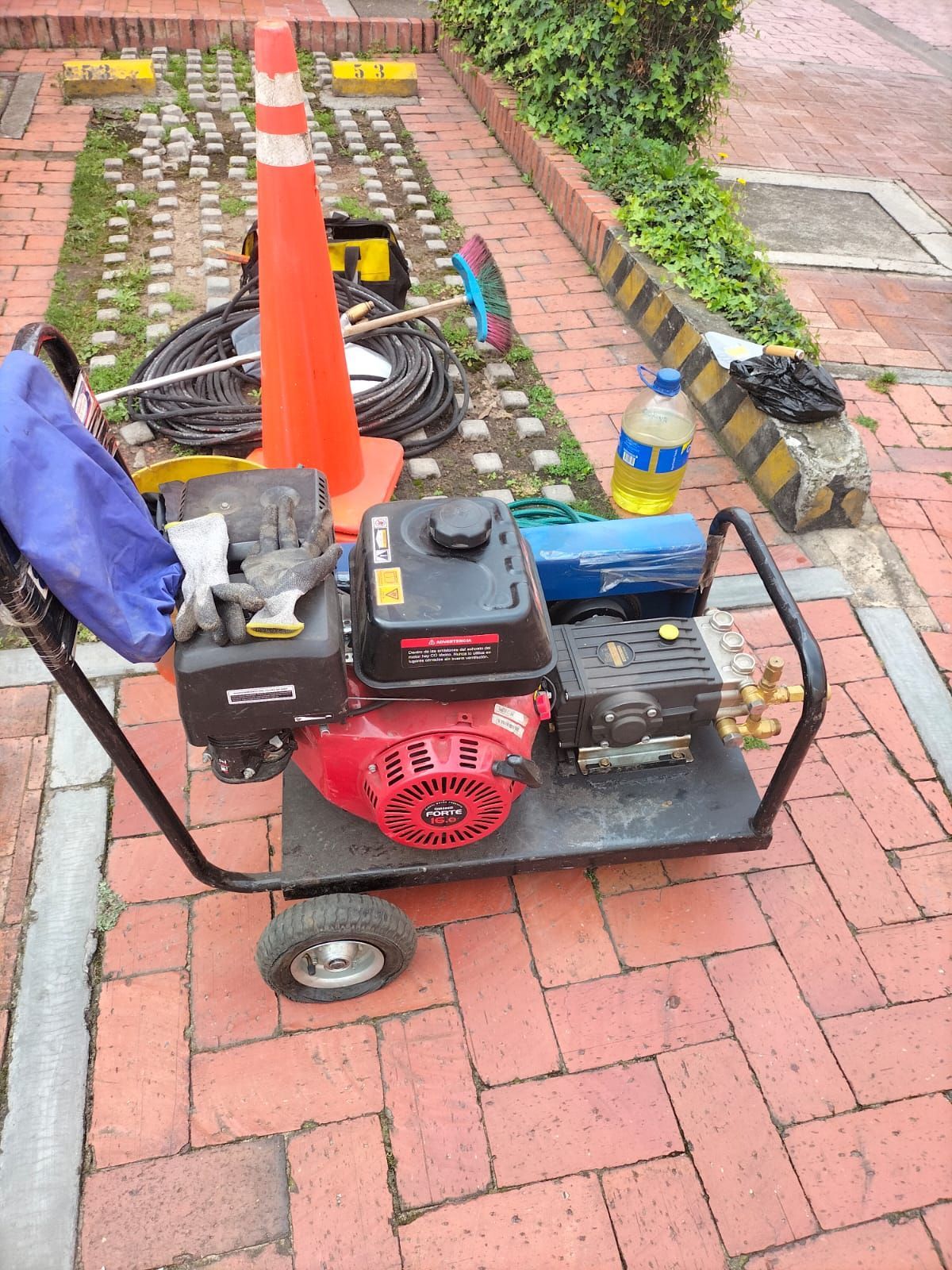 Fontanero instalando un tubo de desagüe de PVC blanco en una abertura del suelo de hormigón.