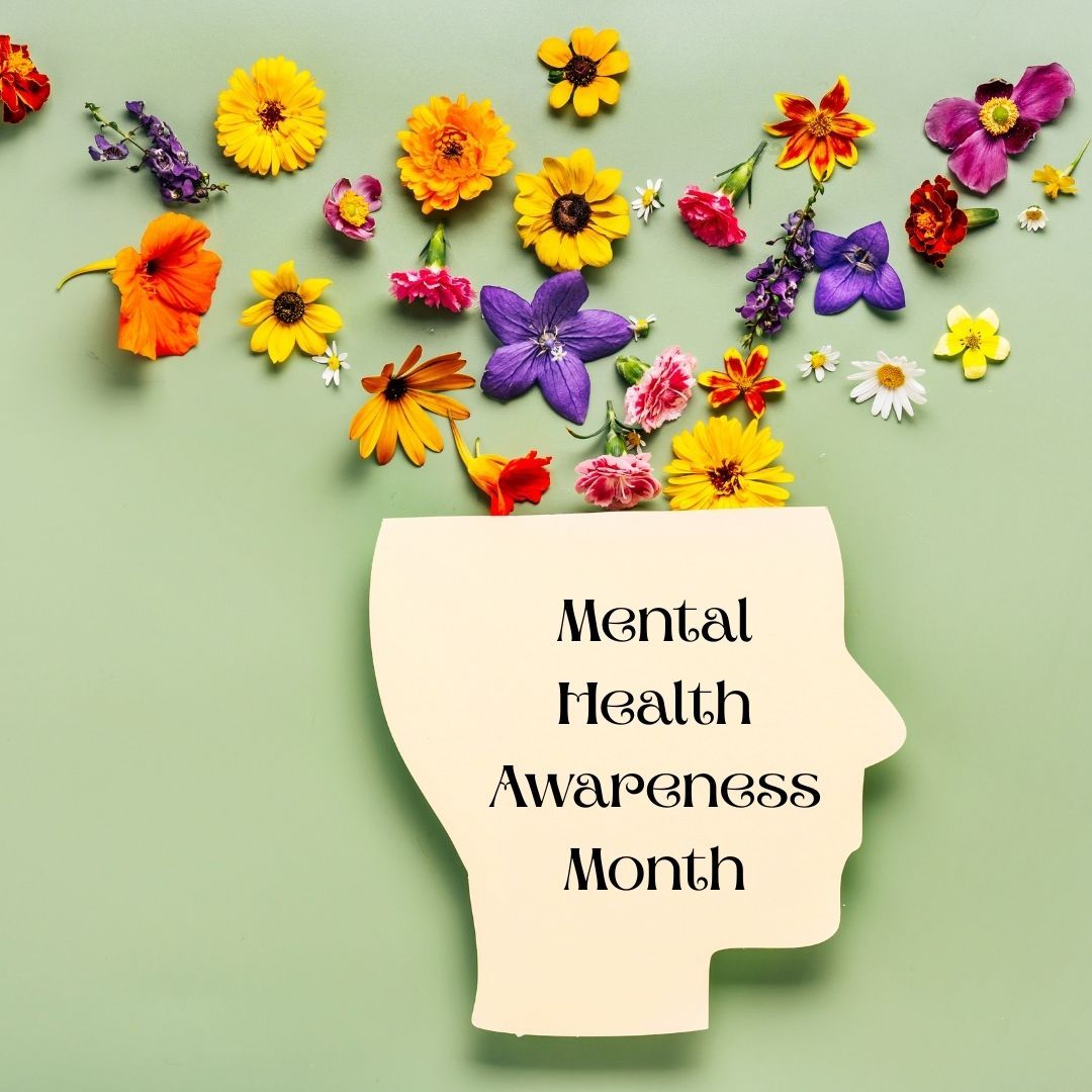 A silhouette of a head with flowers coming out of it for mental health awareness month