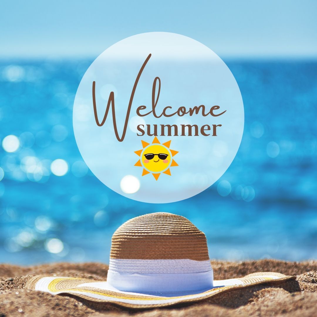 A welcome summer sign with a hat in the sand