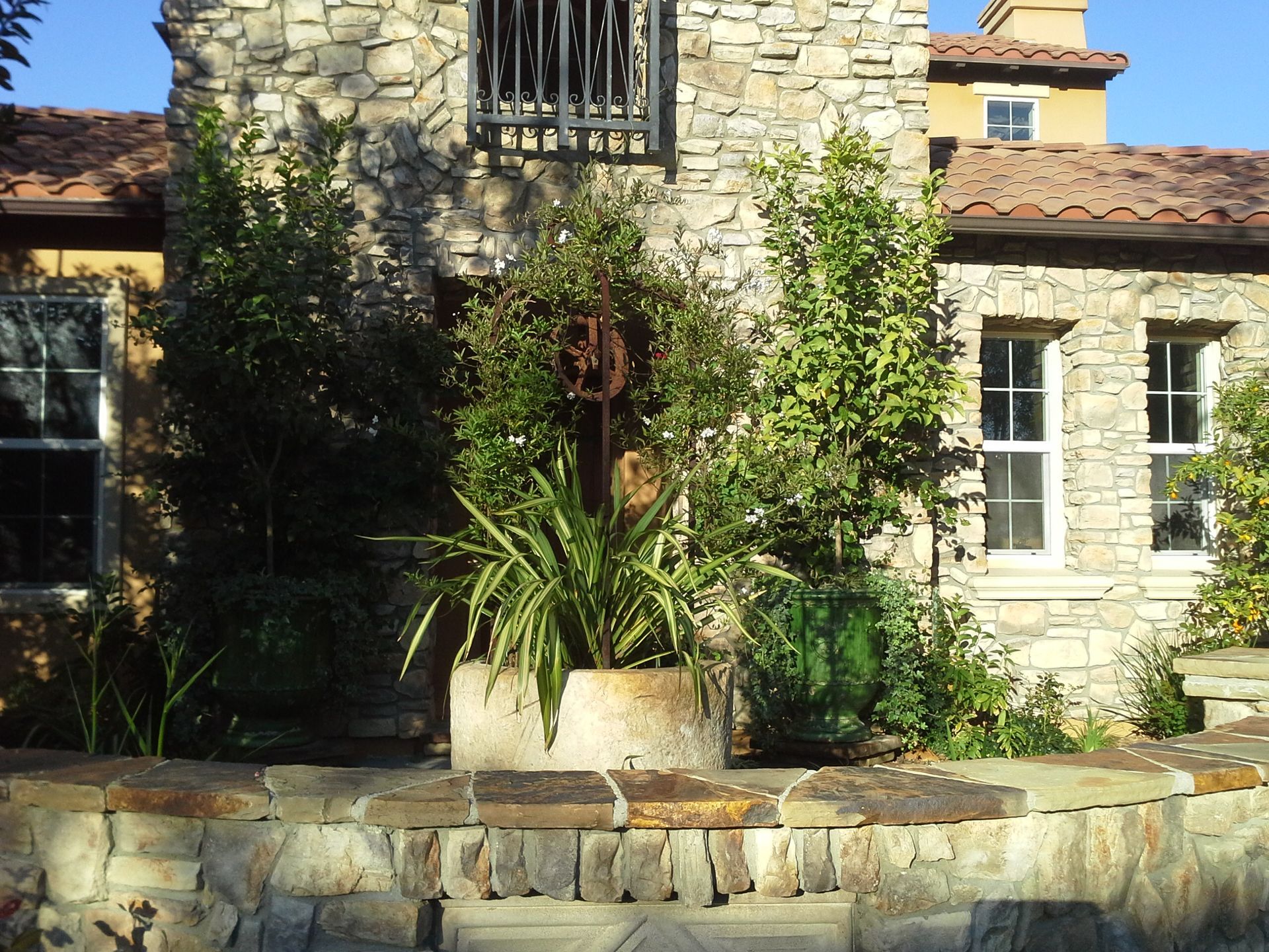 A stone house with a potted plant in front of it