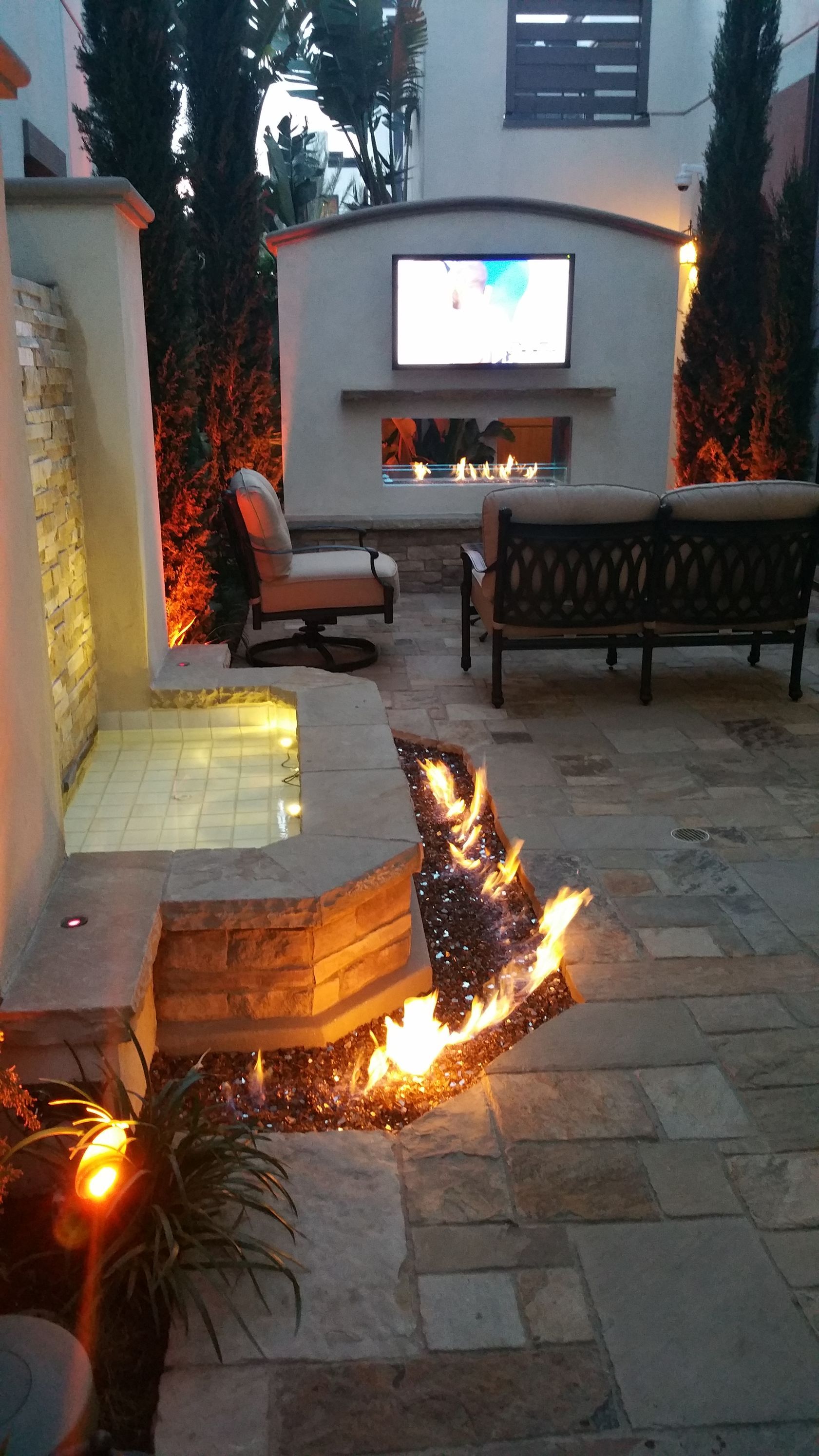 There is a fire pit in the middle of the patio.