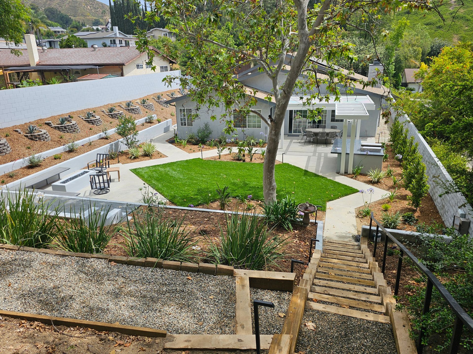 Stairs leading up to a house with a lush green yard