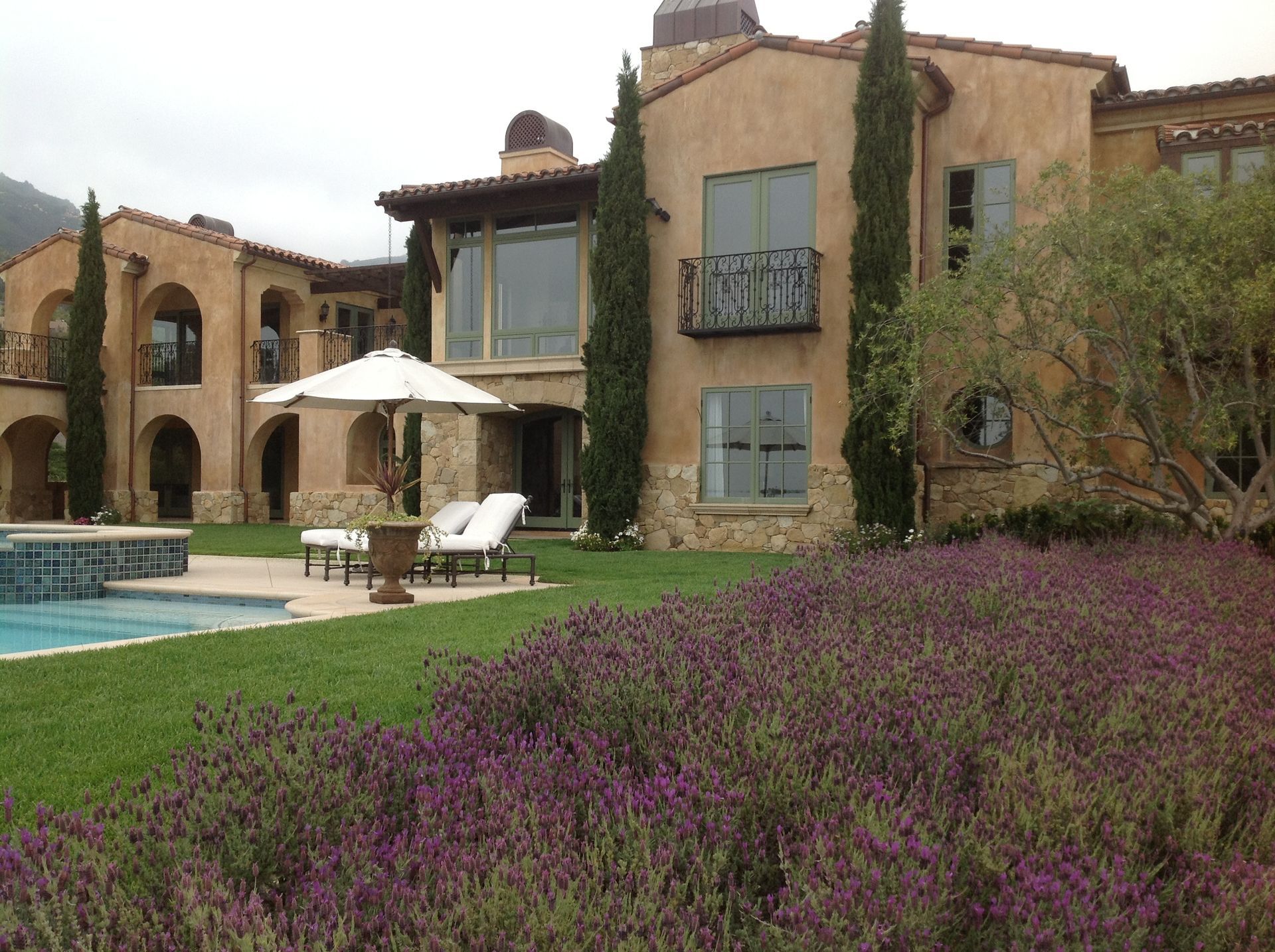 A large house with a swimming pool in front of it